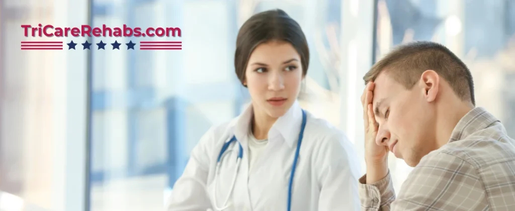 TRICARE military psychiatric hospital coverage concept pic shows plain clothes soldier speaking to a female clinician