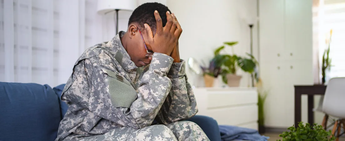 Military substance abuse evaluation concept pic shows female soldier with head in hands