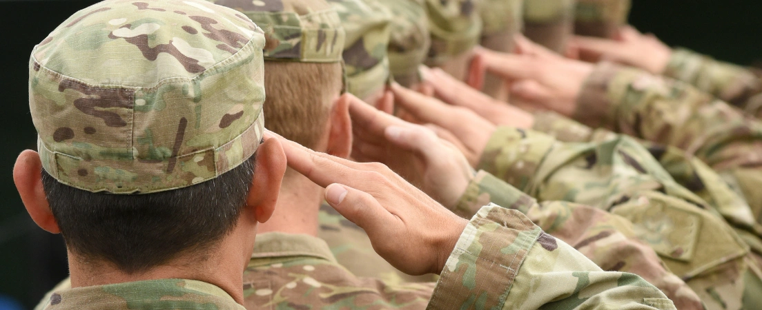 U.S. soldiers saluting, representing military standards and eligibility expectations